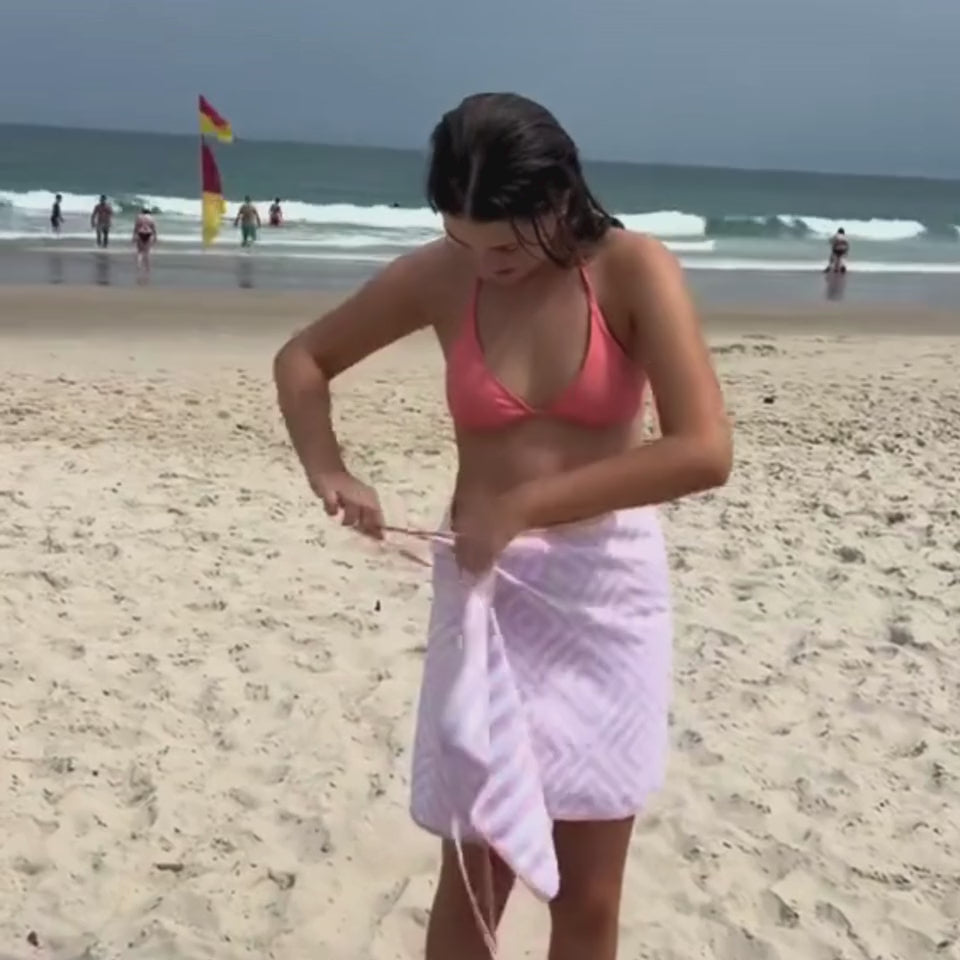 girl shoeing how to put on a towel wrap skirt