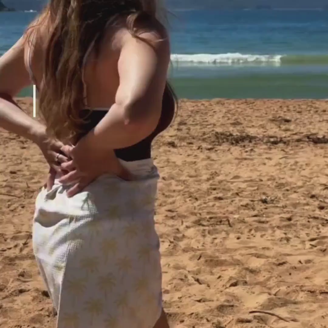 girl wearing towel wrap skirt on the beach