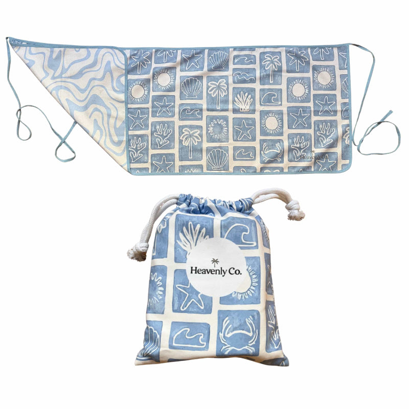 Blue and white patterned towel with drawstring bag on a white background