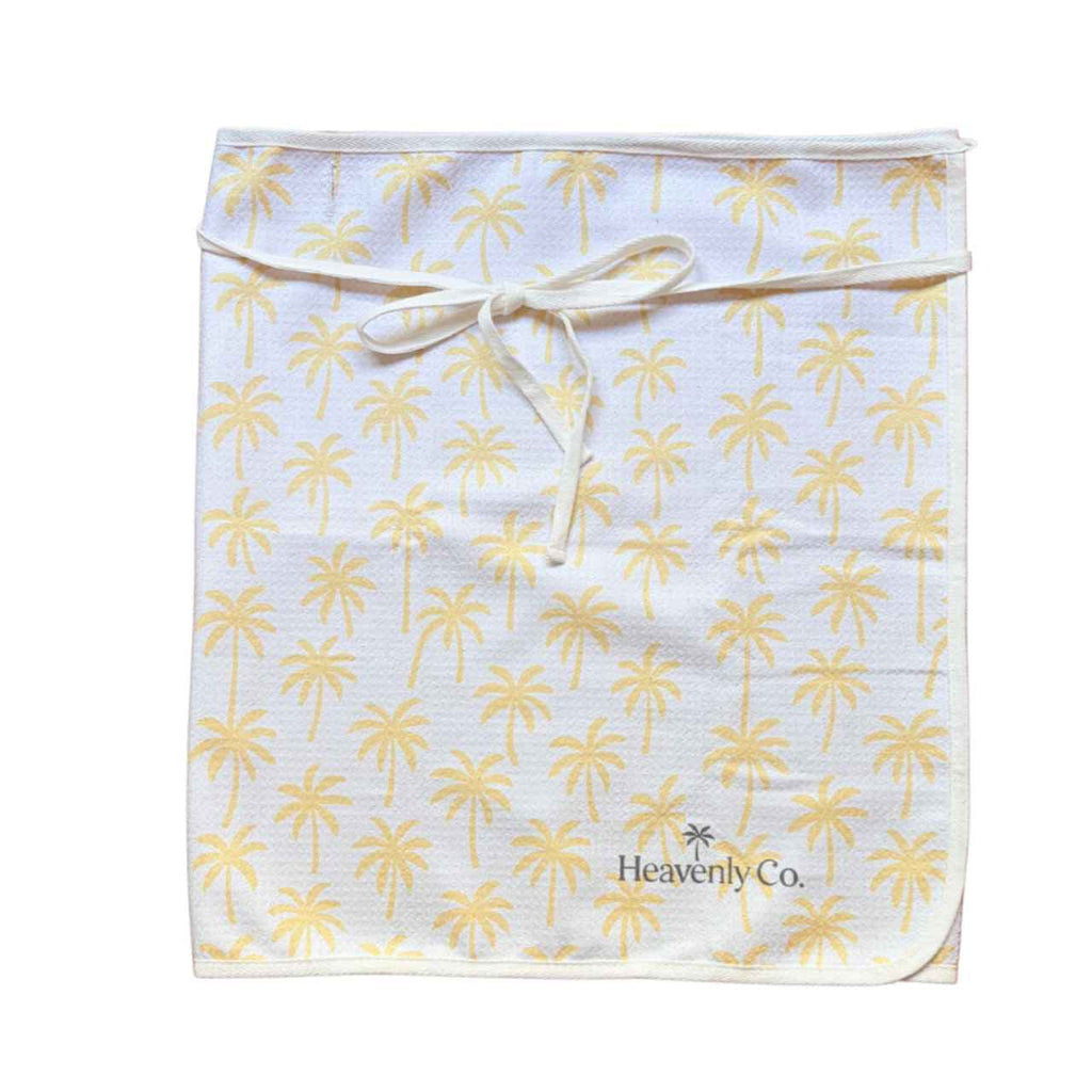 towel wrap skirt with palm tree pattern and 'Heavenly Co.' branding on a white background