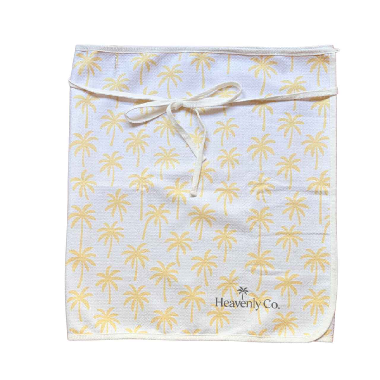 towel wrap skirt with palm tree pattern and 'Heavenly Co.' branding on a white background