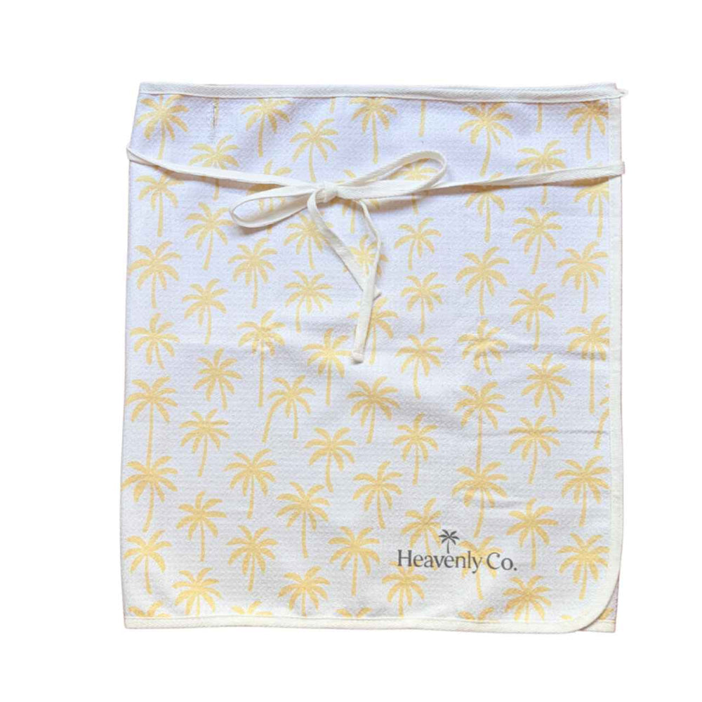 towel wrap skirt with palm tree pattern and 'Heavenly Co.' branding on a white background
