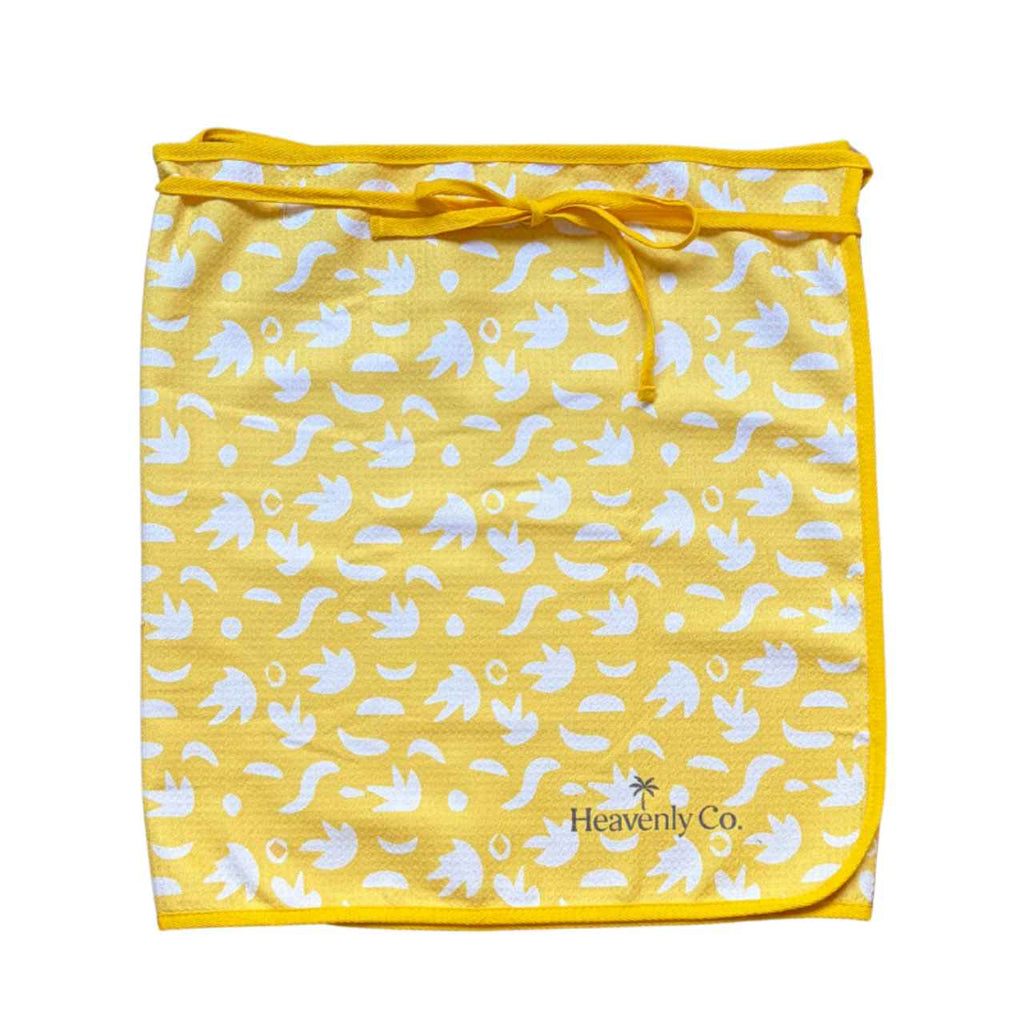 Yellow Towel wrap skirt with white patterns and 'Heavenly Co' branding on a white background