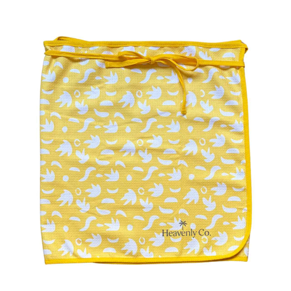Yellow Towel wrap skirt with white patterns and 'Heavenly Co' branding on a white background